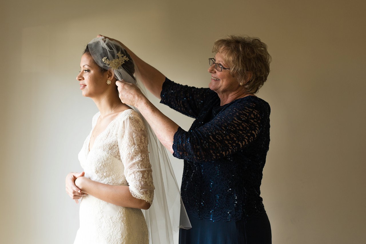 Brides mother helping with veil