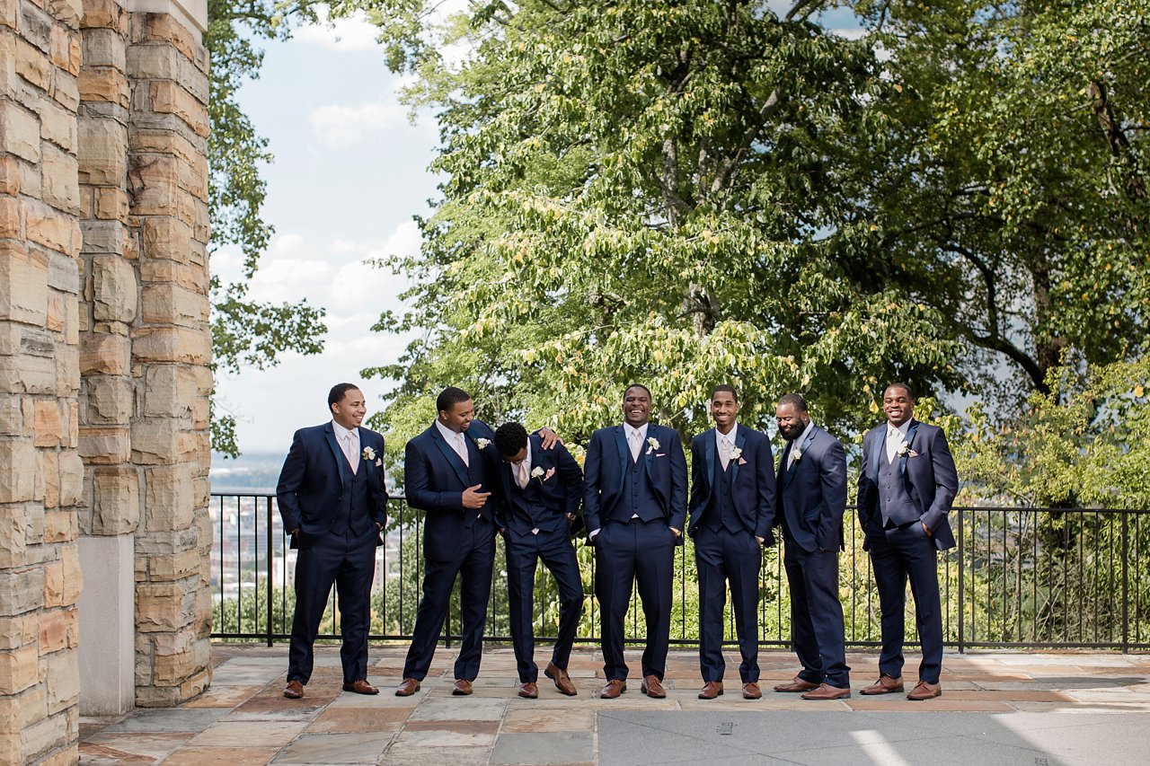 Groomsman share a laugh on wedding day.