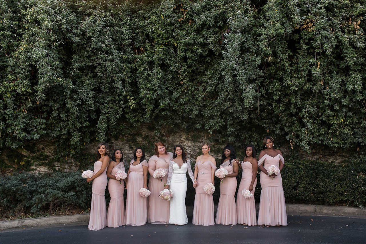 Modern portrait of bridal party, wearing blush tulle dresses in different styles.